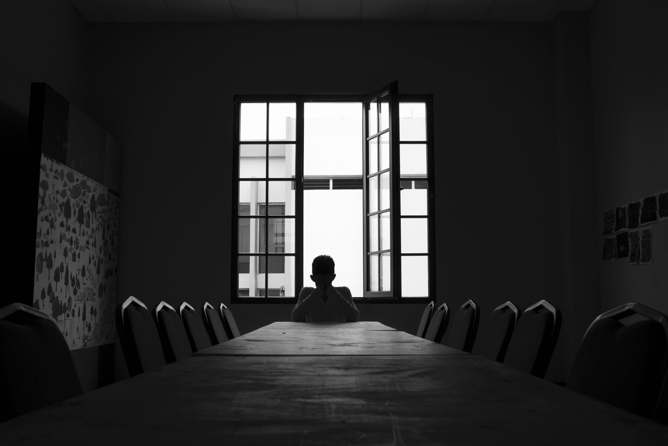 Person in a lonely conference room in a meeting without prupose.
